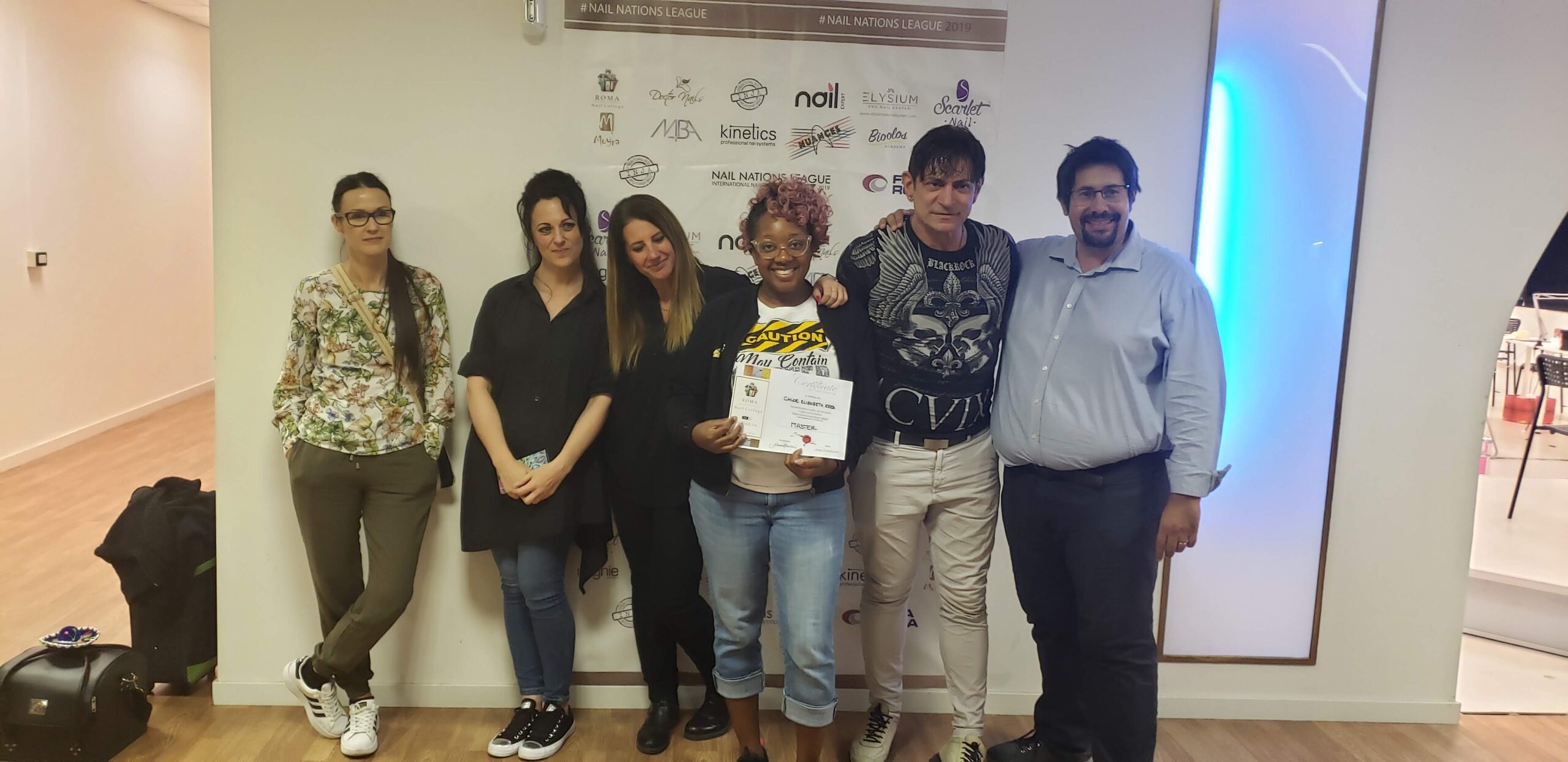 Chloe completing an international nail art training program in Rome, Italy