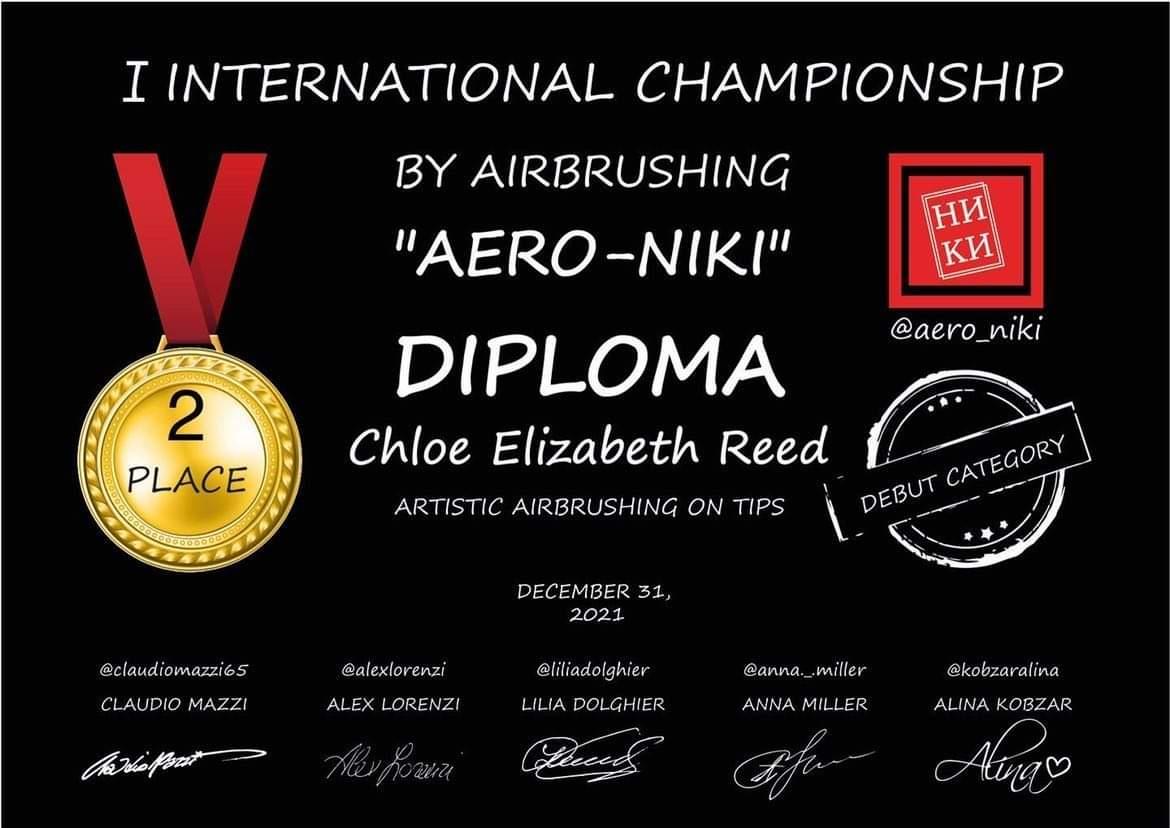 Chloe accepting first place at the Aero Nikki international airbrush competition in Russia, December 2021